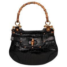 Gucci- Black Studded Shiny Alligator Leather Vintage Bamboo Top Handle Brand: Gucci Model: Bamboo Top Handle Shoulder Bag Product Type: Shoulder, Top Handle Serial Number: 15*********** Accompanied By: Gucci Dust Bag Colour: Black Hardware: Gold Material(s): Shiny Alligator Leather Authenticity Details: Serial Stamp Limited Edition: Yes Height- 22cm Width- 30cm Depth -2cm Handle Drop-15cm Interior- Beige Canvas Closure- Turn Lock Country of Origin- Italy CITES/Export Restrictions- Please note, t Chic Gucci Textured Leather Shoulder Bag, Gucci Black Shoulder Bag With Bamboo Handle, Gucci Black Bag With Bamboo Handle, Black Gucci Bag With Bamboo Handle, Gucci Textured Leather Shoulder Bag, Gucci Shoulder Bag With Bamboo Handle For Daily Use, Formal Black Shoulder Bag With Bamboo Handle, Gucci Shoulder Bag Textured Leather For Daily Use, Gucci Textured Leather Shoulder Bag For Everyday