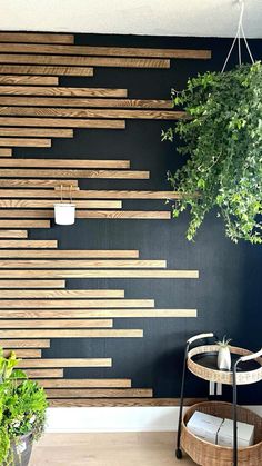 a wooden wall hanging over a table next to a potted plant