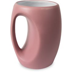 a pink coffee mug sitting on top of a white table