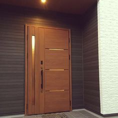 a brown door is in front of a gray wall