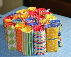 several rolls of colorful paper sitting on top of a blue table with polka dot designs