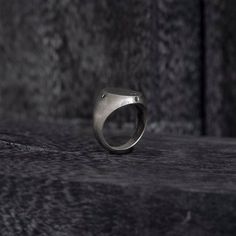 The exquisite Black Diamond Oval Signet Ring, a modern take on a classic style. Crafted from high-quality Sterling Silver, this ring features a unique reworked design that is sure to catch the eye. Adorned with four stunning black diamonds, each measuring 2mm and set on the side as the cardinal points, this ring strikes the perfect balance between elegance and edginess. Sterling silver 925 Signet Ring style Black diamonds 4 pieces, 2mm Ring Face: 20mm by 15mm Thickness: 1-2mm Made in NYC Modern Oval Signet Ring As Promise Ring, Timeless Concave Signet Ring With Polished Finish, Timeless Polished Concave Signet Ring, Timeless Oval Signet Ring With Single Cut Diamonds, Modernist Open Signet Ring For Formal Occasions, Elegant Oval Hand Forged Signet Ring, Modern Rings With Polished Finish, Modern Emerald Ring With Polished Finish For Promise, Modern Oval Engraved Ring With Polished Finish