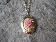 Beautiful cameo locket!!!  The cameo is a gorgeous Rose, choose pink or brown, many other styles and colors available in my shop, so please do browse!!!  The locket is gold plated, victorian style with beautiful scroll on the front and back.  It can hold two photos, keepsakes, or even your daily medication or vitamins!!! The chain is 20" gold plated link chain with a lobster claw clasp!!! Perfect  for Brides or Bridal parties.  Makes a unique memorable gift for any occasion!!!  Timeless classic Pink Medallion Jewelry Gift, Pink Medallion Jewelry For Gifts, Pink Medallion Jewelry As A Gift, Elegant Pink Locket Jewelry, Antique Pink Necklaces For Wedding, Vintage Rose Gold Locket Necklace For Wedding, Vintage Rose Necklace For Wedding, Vintage Rose Jewelry For Valentine's Day, Elegant Pink Necklace For Keepsake