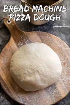 bread machine pizza dough sitting on top of a wooden cutting board