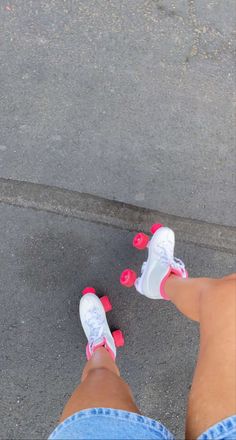 a person with pink and white shoes standing on the street