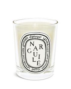 a glass candle that is sitting on top of a white surface with the words, nar