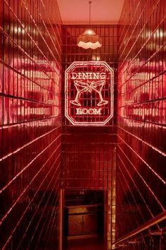 the inside of a room with red lights and metal bars on the walls that are lit up