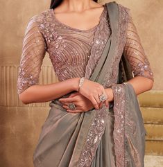 COLOR : Taupe FABRIC : Saree - Fancy Silk, Blouse - Fancy Silk & Net WORK : Resham Embroidery, Stones, Sequins, Lace BorderOCCASION : Wedding, Engagement, Party Wear, Festival, Sangeet NOTE : The outfit includes blouse and saree only. Petticoat is not included. READY-TO-WEAR : No STITCHING : Available as semi-stitched fabric, can be stitched using standard size option (+$30). Note: There might be a slight color variation due to lighting and flash used during photoshoot. The bright shade seen is the best closer view of fabric's color. Taupe Wedding Party, Embroidery Stones, Taupe Wedding, Saree Fancy, Resham Embroidery, Taupe Fabric, Wedding Party Wear, Party Wear Saree, Wear Saree