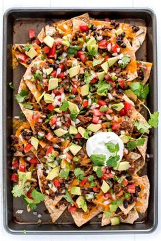 an overhead shot of nachos on a baking sheet