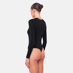 The ERLA Bodysuit is the perfect basic, crafted from an ultra-soft fabric blend that hugs your body flawlessly. Designed for both comfort and style, this bodysuit provides a sleek, form-fitting silhouette, making it an essential piece for any wardrobe.Size and fit:• The bodysuit runs small; we suggest sizing upInfo:• 48% cotton, 48% modal, 4% spandex• Gusset hook and eye closure with thong back• Machine wash (mild detergent, iron, no bleaching, dry flat, do not tumble dry)Model info:• 5' 10"/177 Sleek Compressive Bodysuit, Sleek Micro-elastic Solid Bodysuit, Sleek Seamless V-neck Bodysuit, Seamless V-neck Elastane Bodysuit, V-neck Nylon Bodysuit With Lined Body, Confident Style, Modal Fabric, Elegant Party, Welcome To The Party