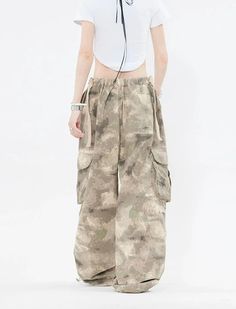 Embrace the street aesthetic with our Faded Baggy Camo Cargo Pants, perfect for making a statement while on the move.
Designed with a natural waist, these cargo pants offer a blend of comfort and durability. The camouflage pattern adds an edgy touch, while the drawstring and convenient pockets provide functionality and ease. The relaxed wide-leg silhouette ensures a nonchalant yet purposeful style, tailored for the contemporary wardrobe.
Pair them with a cropped hoodie and sneakers for running e Spring Cotton Combat Cargo Pants, Spring Combat Cotton Cargo Pants, Summer Combat Cotton Bottoms, Combat Style Baggy Wide Leg Bottoms, Baggy Hip Hop Parachute Pants For Summer, Combat Style Wide Leg Parachute Pants With Side Pockets, Wide-leg Cargo Pants With Multiple Pockets For Streetwear, Hip Hop Baggy Parachute Pants For Summer, Summer Hip Hop Baggy Parachute Pants