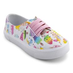 a child's white sneaker with colorful pictures on it