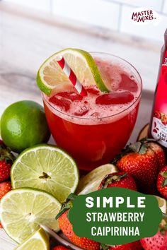 a drink with strawberries and limes next to it