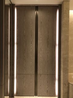 an elevator with two doors and lights on each side