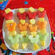 mickey mouse shaped fruit skewers on a plate