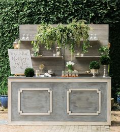 an outdoor bar with potted plants on it