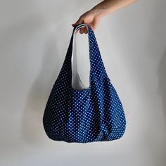 "This hobo tote bag is the perfect size for going around town with enough room for everything without looking bulky. There's a small magnetic closure at the top, it has a convenient interior pocket for your cell phone and it is fully lined with cotton canvas to give it extra durability and structure. * Height from top of strap to bottom of bag : 20 inches / 50 cm * Height not including strap: 11 inches / 28 cm * Width: 16 inches / 40 cm * Pocket: 3.5\" x 5.5\" / 9 cm x 14 cm * Exterior: Cotton * Blue Reversible Shoulder Bag With Double Handle, Reversible Blue Shoulder Bag With Double Handle, Blue Reversible Tote Shoulder Bag, Reversible Blue Tote Shoulder Bag, Reversible Blue Shoulder Bag For Shopping, Blue Handheld Hobo Bag For Everyday Use, Handheld Blue Hobo Bag For Everyday Use, Blue Reversible Shoulder Bag For Daily Use, Blue Handheld Hobo Bag With Removable Pouch