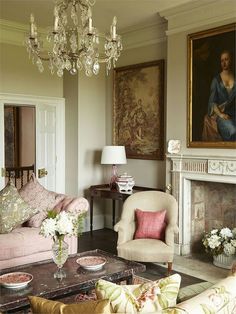 a living room filled with furniture and a chandelier