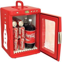 an open red mini fridge with soda and soft drinks in it