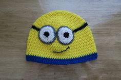 a crocheted yellow and blue hat with eyes