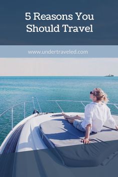 a woman sitting on the bow of a boat looking out to sea with text overlay that reads 5 reasons you should travel