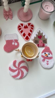 knitted coasters and tea cozyies on a table