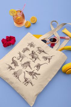 a tote bag sitting on top of a table next to scissors and lemons