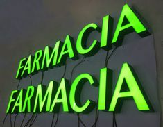 the words farmacia are lit up in green