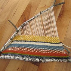 a multicolored weaving is laying on the floor