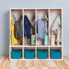 a white cubby filled with lots of clothes