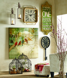 a living room filled with lots of furniture and art on the wall next to a clock