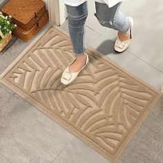 a woman standing in front of a door with her feet up on the entrance mat