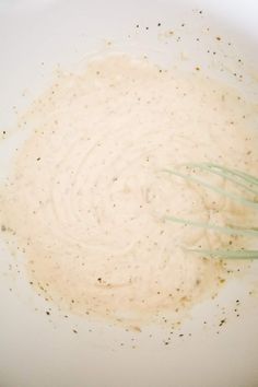 a white bowl filled with batter and whisks