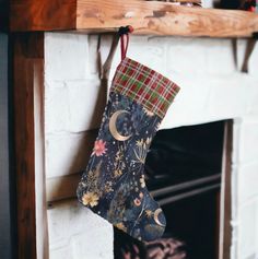 a christmas stocking hanging from a fireplace mantel