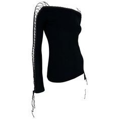 From the early 2000s, this fabulous black knit Dolce & Gabbana lace sweater is elevated with a lace-up detail that runs up both sleeves. This sultry sweater is made complete with a bateau neckline and cords that ties at the wrist. Add this chic Dolce & Gabbana vintage sweater to your wardrobe! Approximate measurements: Size - 42IT Shoulder to hem: 21" Bust: 28 - 36" Waist: 28 - 36" Shoulder to cuff: 25" Underarm to cuff: 19" 89% Viscose, 11% Polyester Dolce And Gabbana Clothes, Vintage Dolce And Gabbana, Lace Turtleneck Top, Fashion Sketchbook Inspiration, Black Lace Corset Top, Long Sleeve Corset Top, Top In Pizzo, Long Sleeve Corset, Black Lace Corset