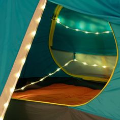 the inside of a tent with lights on it