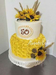 a 50th birthday cake decorated with sunflowers and pearls