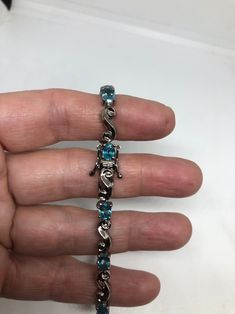 This Blue Topaz bracelet is very lively and bright. The stones are deep colors and well matched. The sterling silver is very solid with antiqued rhodium finish 7.5 inches My jeweler can shorten this for a $20 fee All jewelry is shipped in a nice gift box. Check out our over a THOUSAND great reviews Engraving is $4 per letter and is not always perfect depending on the piece. It can take a few days if the jeweler is busy. This is payable to Paypal Judithsltd@gmail.com Fine Jewelry Silver Bracelet With Blue Topaz, Silver Blue Topaz Bracelet Fine Jewelry, Silver Blue Topaz Bracelets Fine Jewelry, Silver Blue Topaz Bracelets As Gift, Silver Blue Topaz Bracelets For Gift, Blue Gemstone Sterling Silver Bracelet, Blue Birthstone Bracelets In Fine Jewelry Style, Silver Blue Topaz Bracelets For Anniversary, Silver Blue Topaz Bracelet For Anniversary