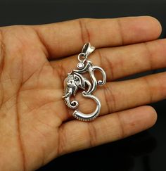 Indian Hindu Idols god Ganesha with om or 'Aum' design vintage antique style pendant, best gifting unisex jewelry from India. Metal-925 sterling silver. Item type-Pendant/ Locket Weight-9.730 grams. height-4.8 centimeter. Width-2.5 centimeters. Stamped-925. Finish-Oxidized. note :chain is not include in this price, to purchase chain please visit following links: https://www.etsy.com/listing/823425858/16-to-30-long-screw-chain-925-sterling?ref=listings_manager_grid Make excellent gifting and coll Silver Symbolic Jewelry For Diwali, Symbolic Silver Jewelry For Festivals, Spiritual Engraved Jewelry For Diwali, Sterling Silver Jewelry For Diwali, Silver Engraved Jewelry For Diwali, Engraved Jewelry For Diwali Gifts, Diwali Gift Pendant Jewelry, Handmade Sterling Silver Jewelry For Diwali, Silver Jewelry For Diwali Anniversary