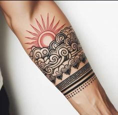 a woman's arm with a sun and clouds tattoo on it