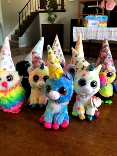 several stuffed animals wearing party hats on a table