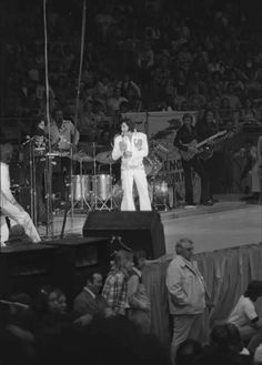 elvis presley performing on stage in front of an audience