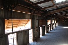 the inside of a building with wooden floors and beams on it's side wall