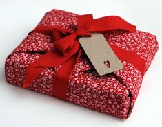 a red wrapped gift with a tag on it