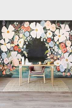 a floral wall mural in a dining room with a table and chairs on the floor