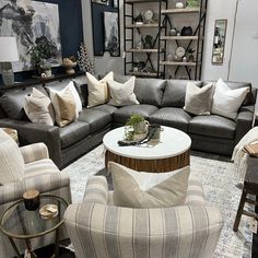 a living room with couches, chairs and tables in the middle of it's display area