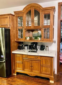 a kitchen with wooden cabinets and black appliances