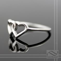 Two hearts combined can create infinite love! This ring has two interlocking hearts, fused together as one. A perfect symbol of love and commitment. The band is round and smooth and about 1.3mm wide. The two hearts are about 7.5mm tall. These rings are all solid, no plating. The fourth and fifth pictures shows the ring in solid 14k rose gold. This ring is made to order in your size and choice of metal. Please select from the options available and allow 1-2 weeks for your ring to be finished. Che Nickel-free Stackable Promise Rings, Minimalist Double Heart Anniversary Rings, Adjustable Heart-shaped Stackable Promise Rings, Sterling Silver Infinity Heart Promise Ring, Elegant Adjustable Nickel-free Heart Ring, Sterling Silver Open Heart Stackable Promise Rings, Adjustable Double Heart Rings For Wedding, Sterling Silver Infinity Heart Ring For Wedding, Sterling Silver Infinity Heart Wedding Ring