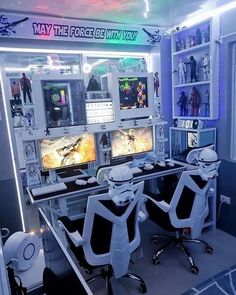 a room with two desks that have computers on them