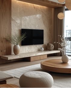 a living room filled with furniture and a flat screen tv on top of a wall